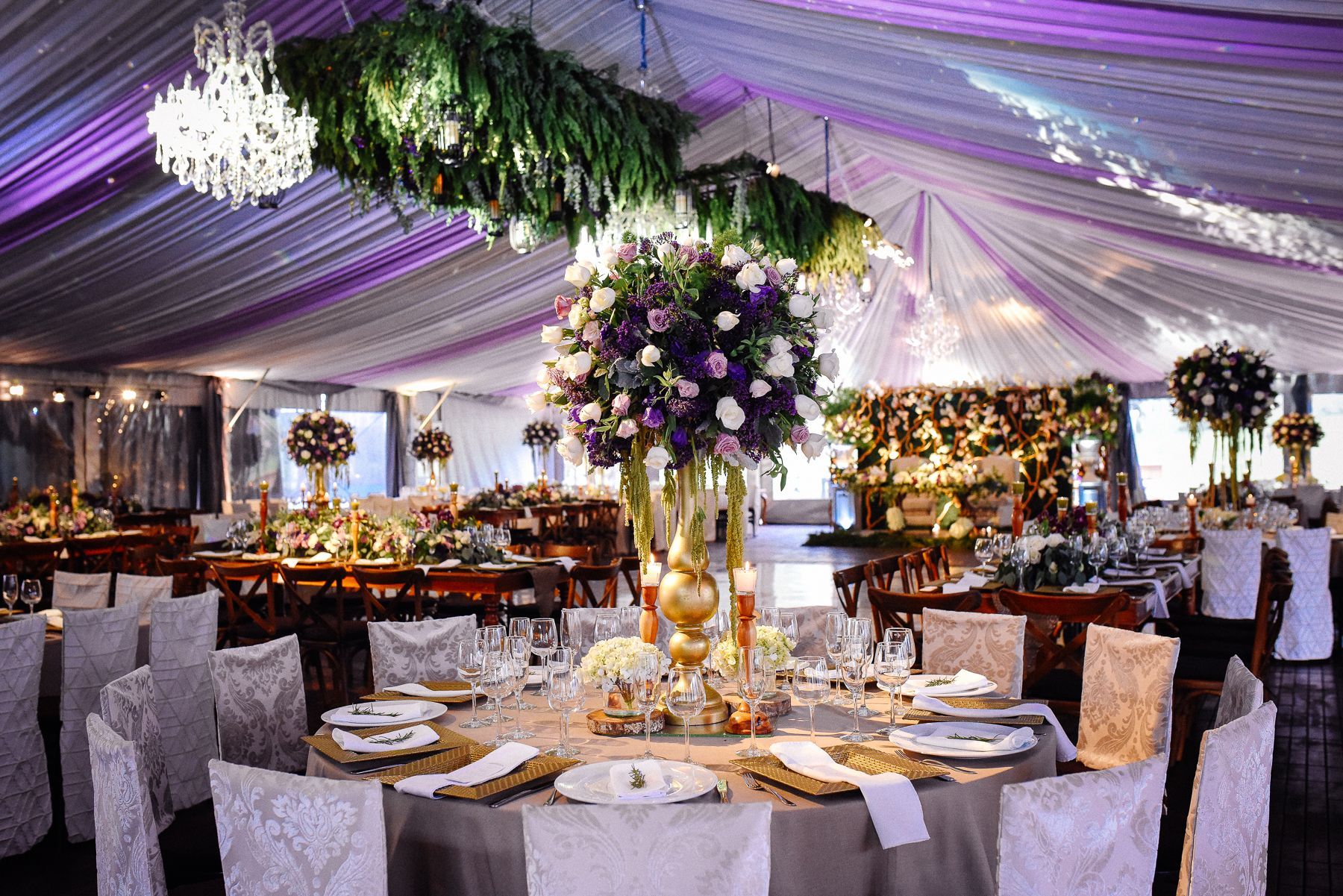 A large room with tables and chairs set up for a wedding reception.