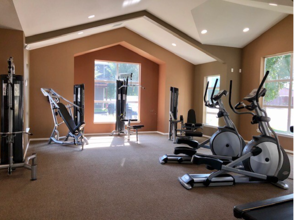 Three-Bedroom Apartments in Keizer, OR - Hawk's Point Apartments - Fitness Center With Cardio Machines, Strength Equipment, Vaulted Ceiling, Large Windows, and Open Workout Space.