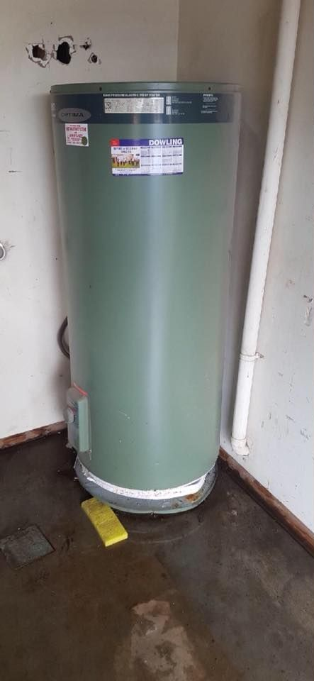 Water Heater Leaking on a Wet Floor, Next to a Wall — Hunter Plumbing And Hotwater in Raymond Terrace, NSW