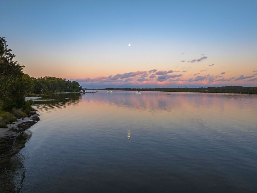 Sunset Over Calm Water, Reflecting the Sky's Pink and Blue Hues — Hunter Plumbing And Hotwater in Lemon Tree Passage, NSW