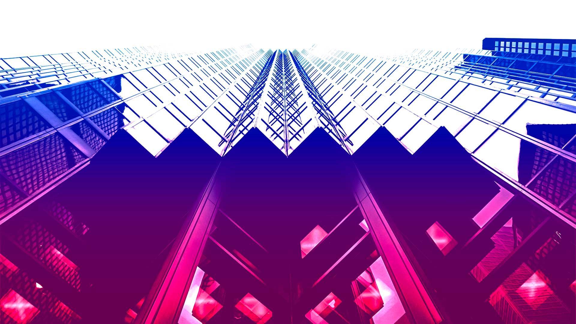 Bottom up wide angle view of a glass building with a neon tint