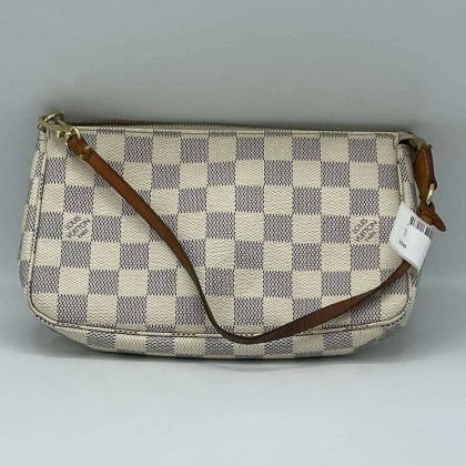 A white and gray checkered louis vuitton purse with a brown strap.