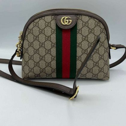 A gucci purse with a red , green and white stripe on it.
