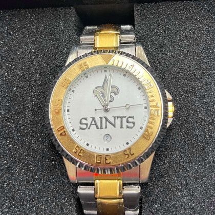 A silver and gold watch with the word saints on the face