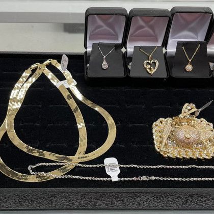 A display of gold jewelry including necklaces and bracelets