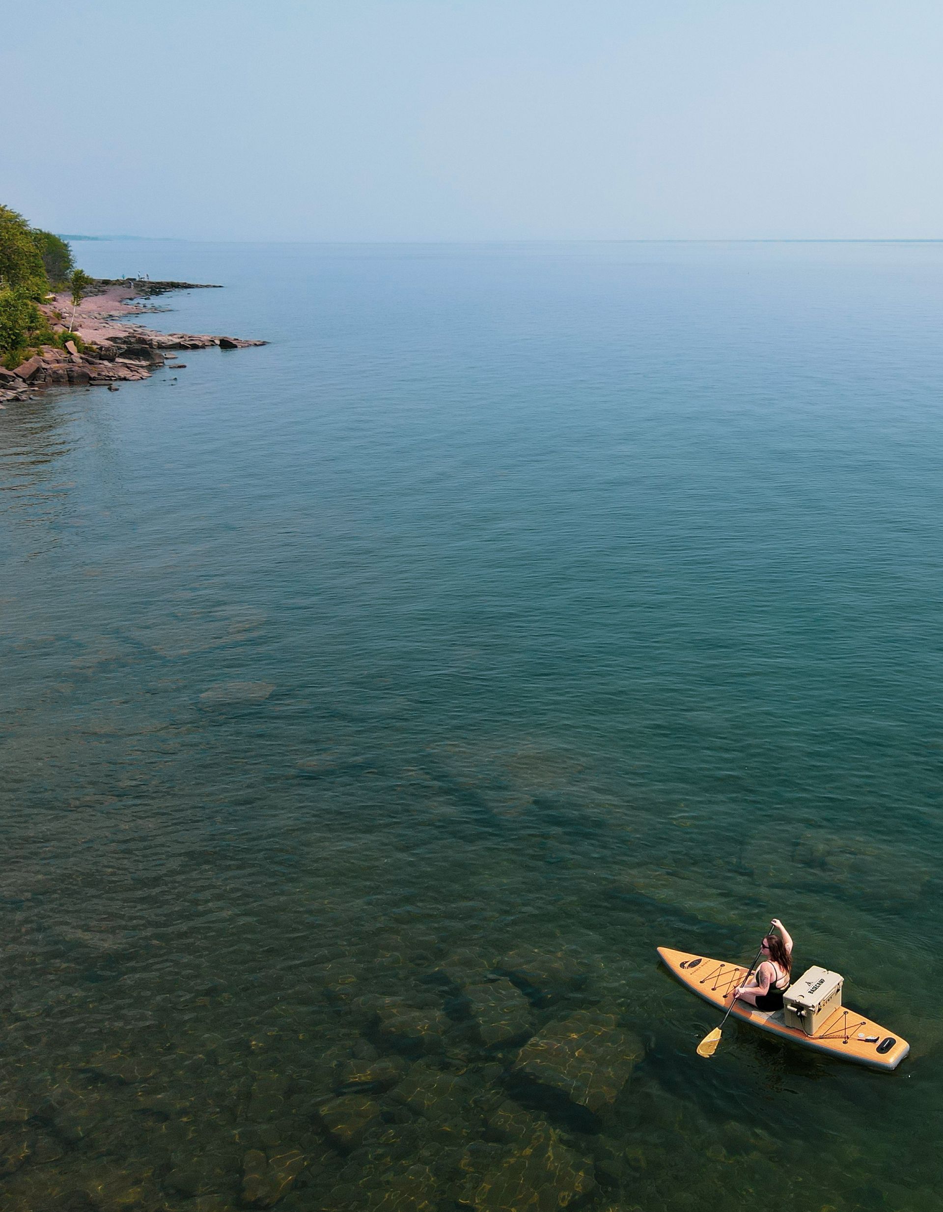 paddleboarder on Lake Superior by the shore