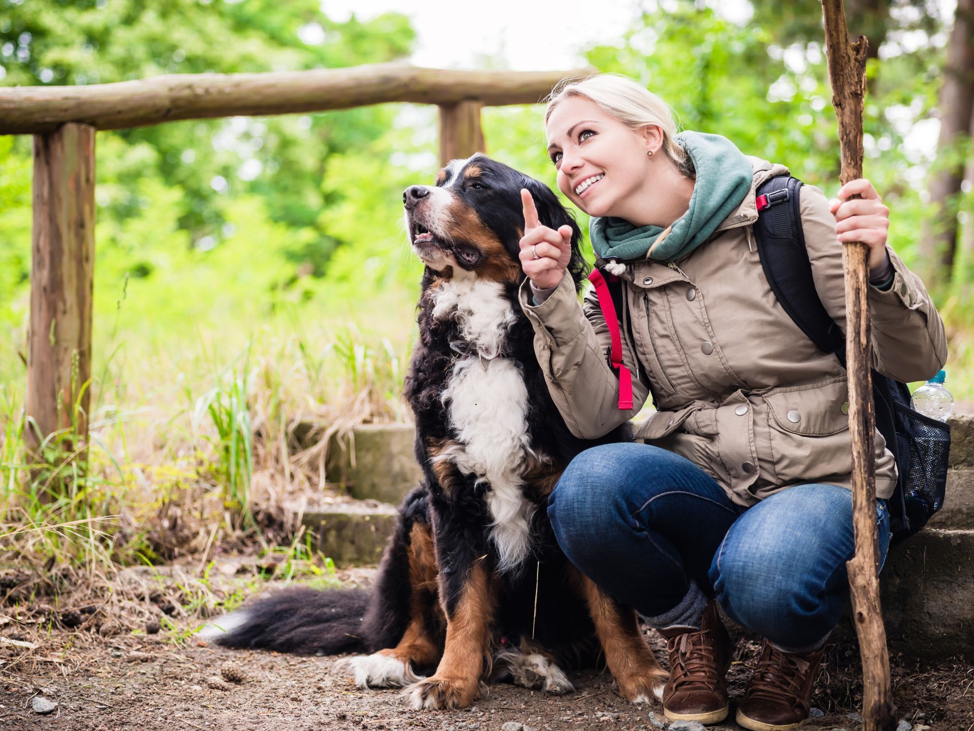 person hiking with their dog pointing at something