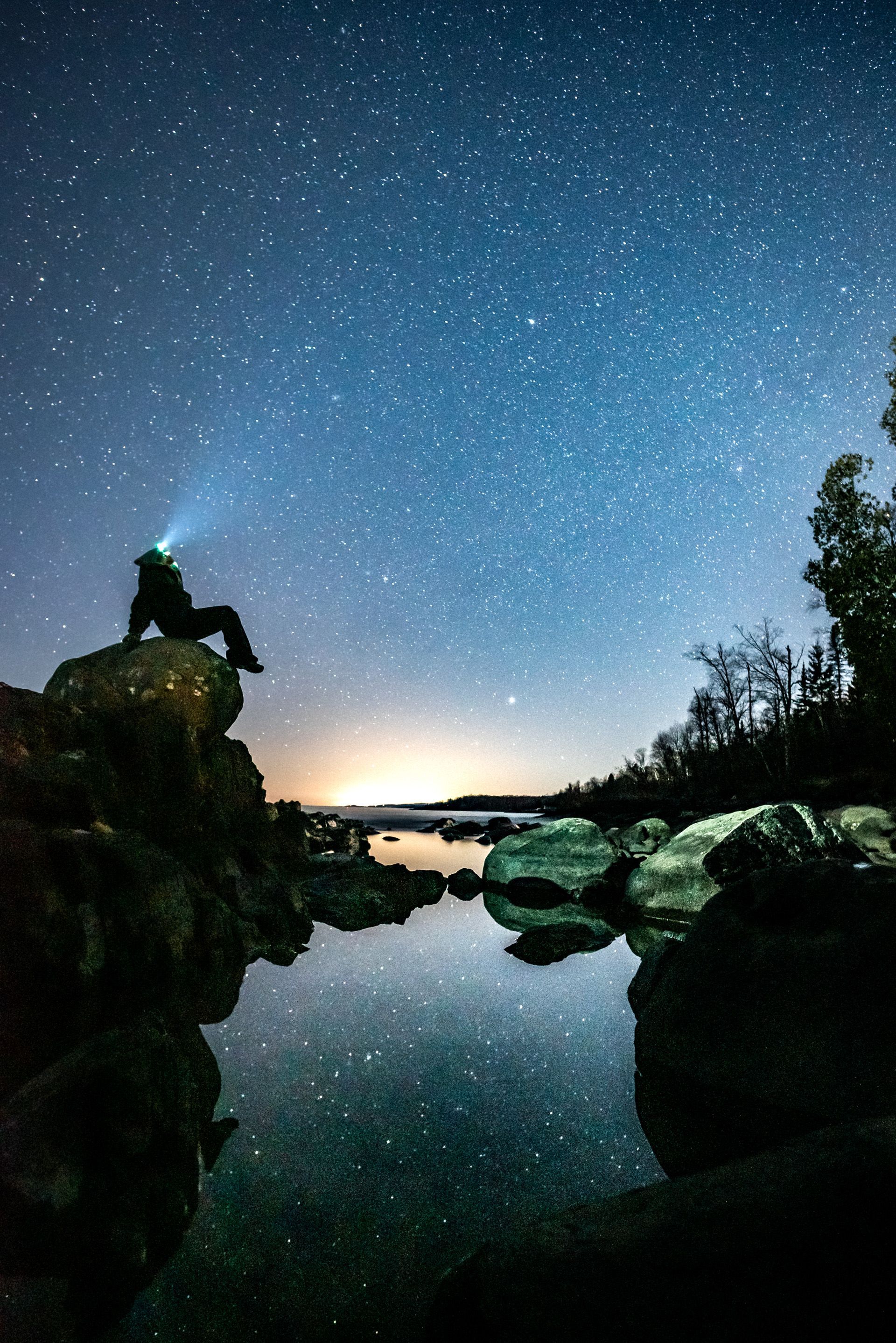 hiker below a starry night