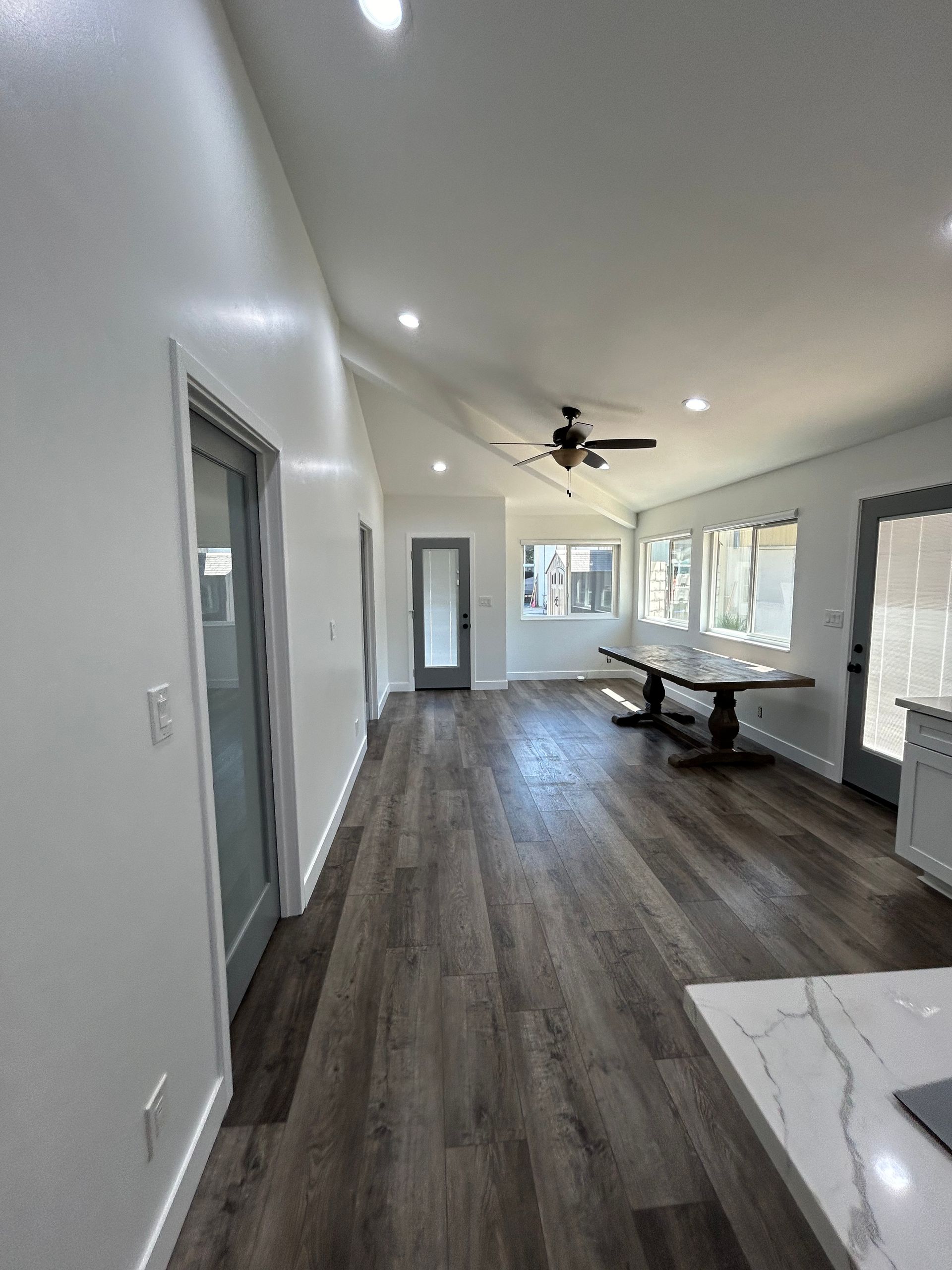 An empty room with hardwood floors and a window