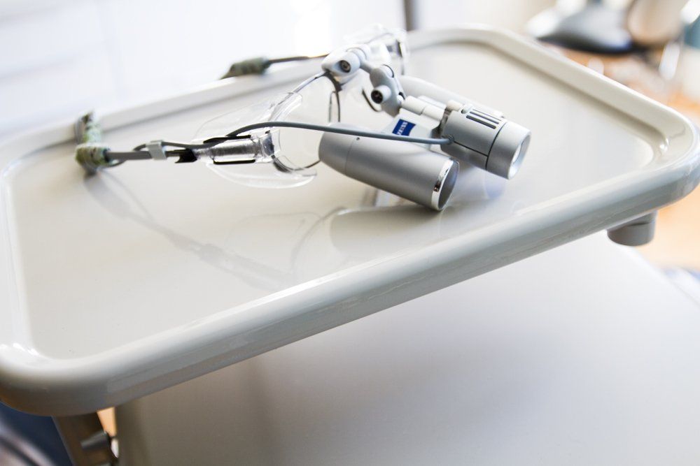 A pair of magnifying glasses sitting on top of a white tray.