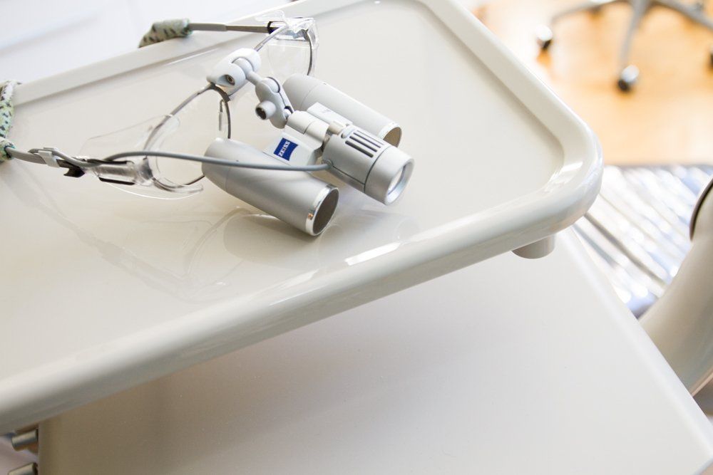 A dental pair of magnifying glasses sitting on top of a white table.