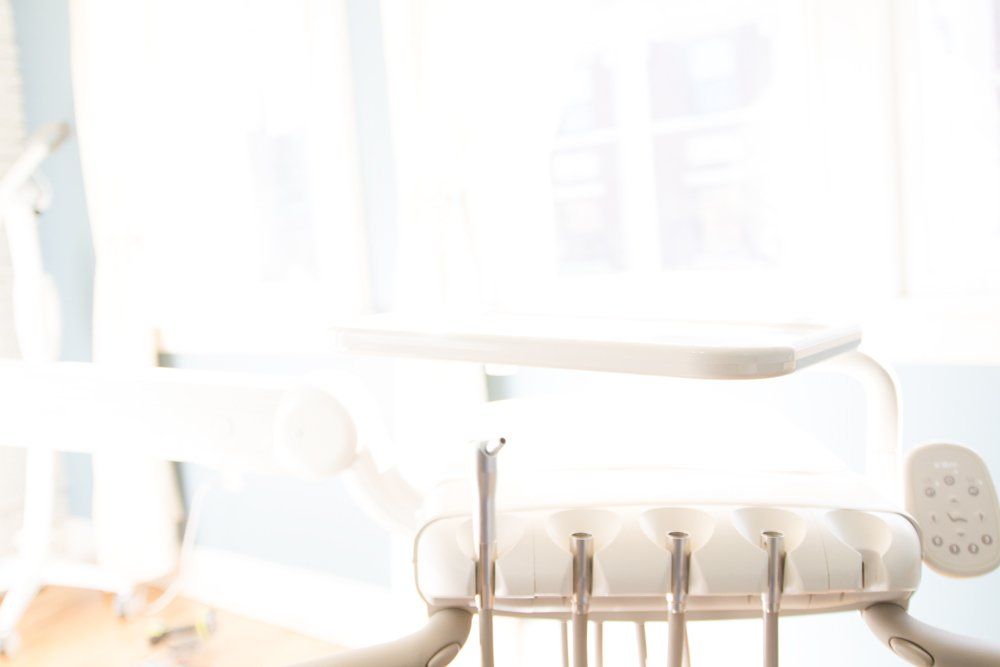 A close up of a dental chair with dental instruments in a dental office.