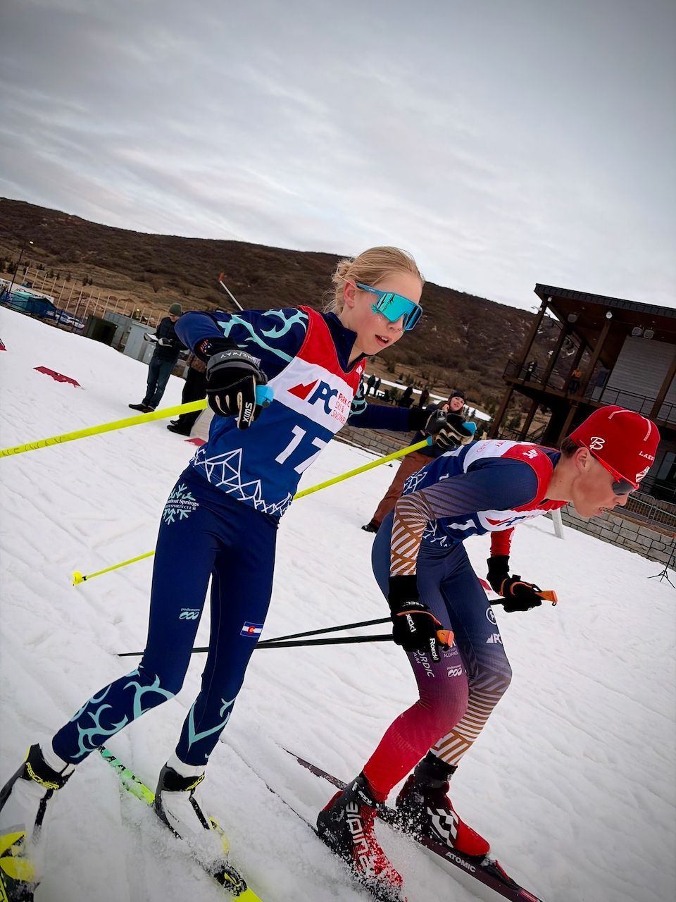 Relay teammates Liam Demong (PCSS) and Clara Keller (SSWSC) tagging off.
