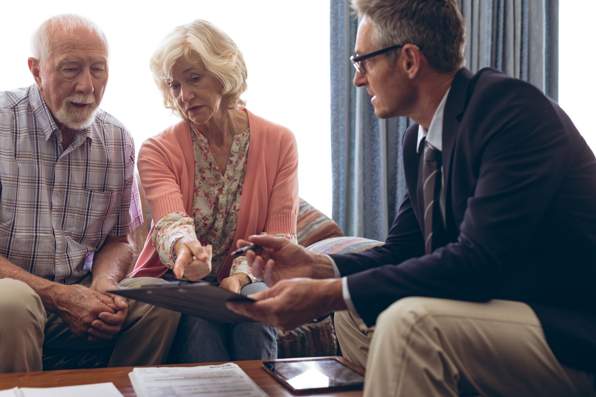 Doctor consulting with a senior couple about long-term care planning and health options