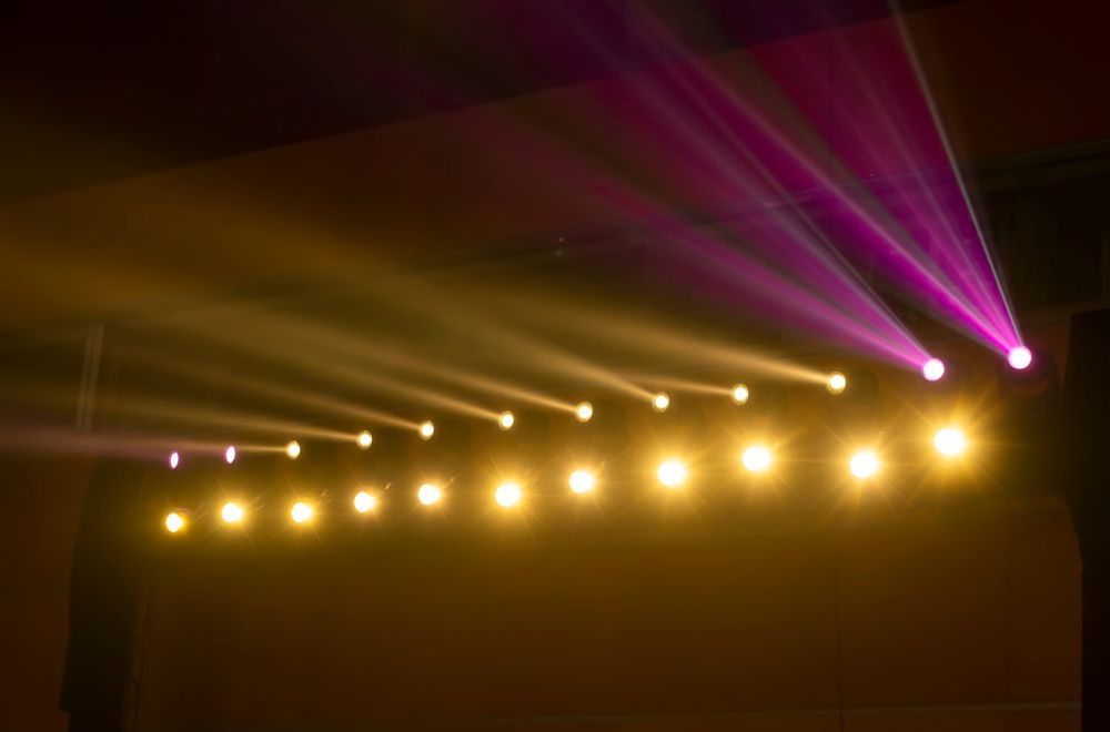 Yellow and Purple Stage Lights Illuminate a Dark Setting — Kennedy Amplifier Hire Service In South Mackay, QLD