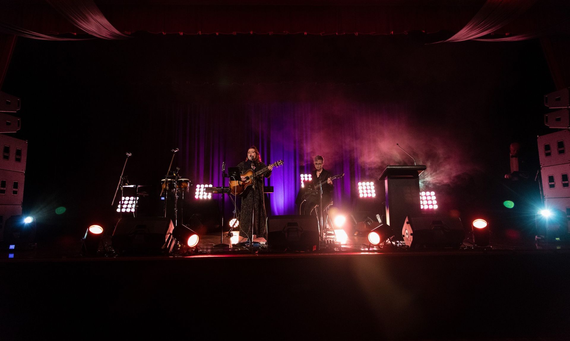 Band Performing On Stage With Purple And White Stage Lighting — Kennedy Amplifier Hire Service In South Mackay, QLD