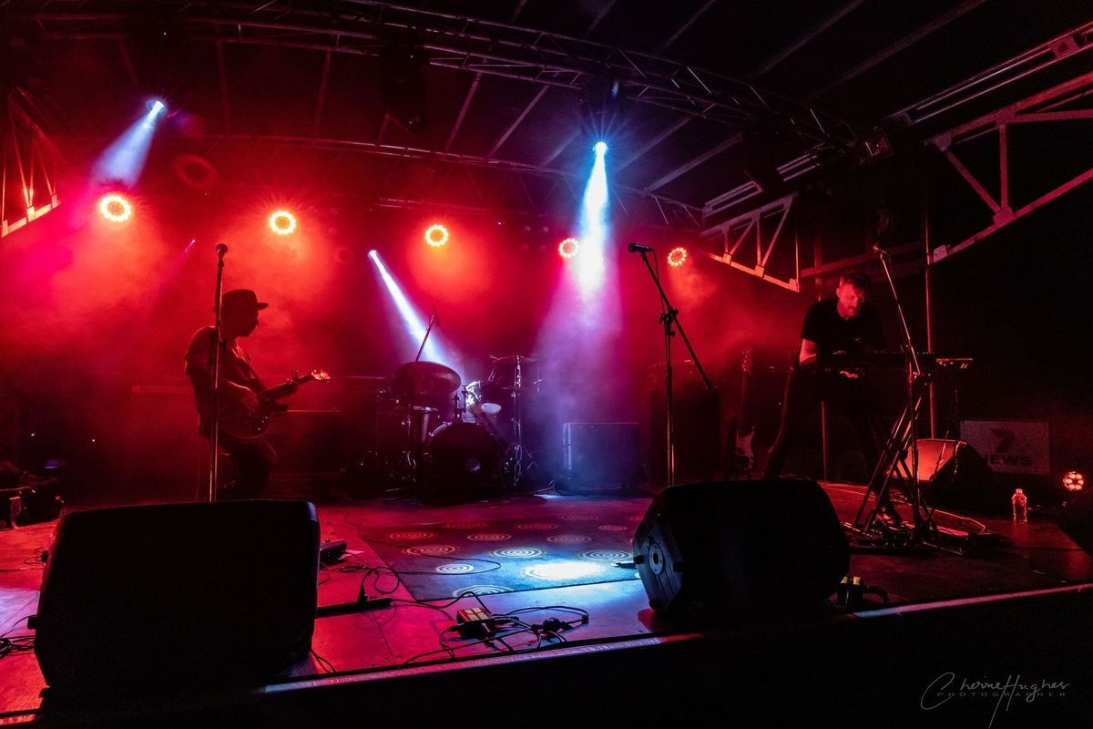 Band Performing On Stage, Bathed In Red And Blue Stage Lighting — Kennedy Amplifier Hire Service In South Mackay, QLD