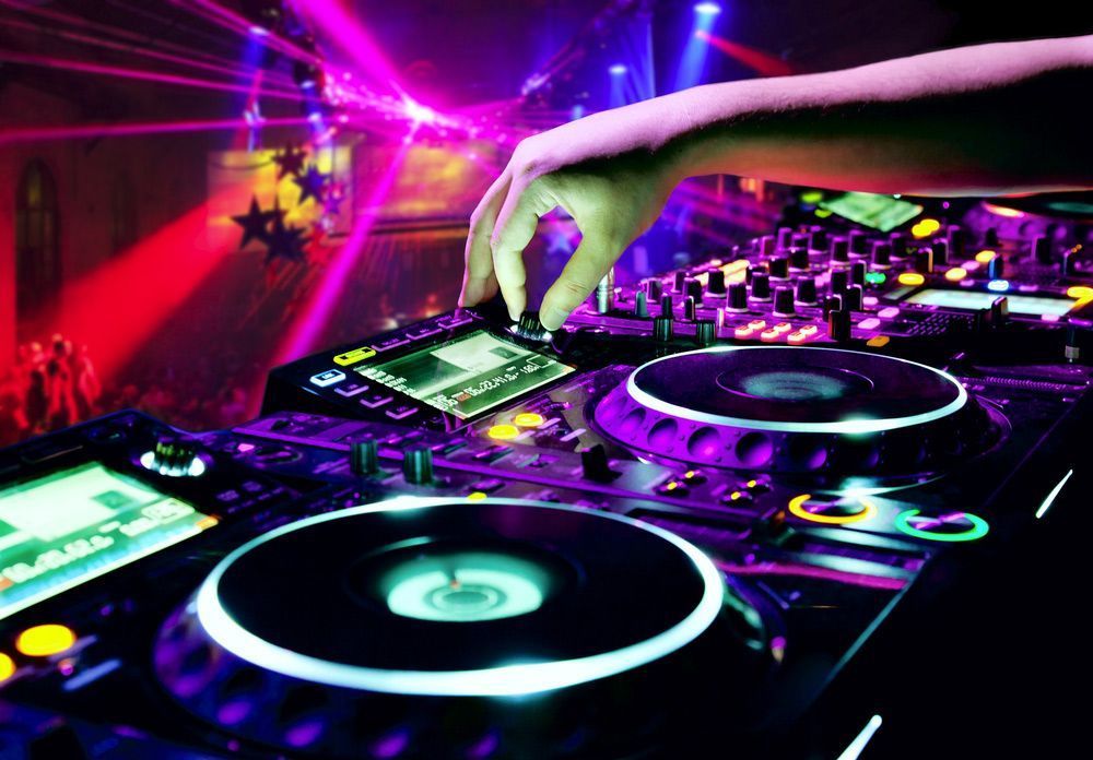 Dj At Work In A Dimly Lit Club, Using Turntables And Mixing Board — Kennedy Amplifier Hire Service In South Mackay, QLD