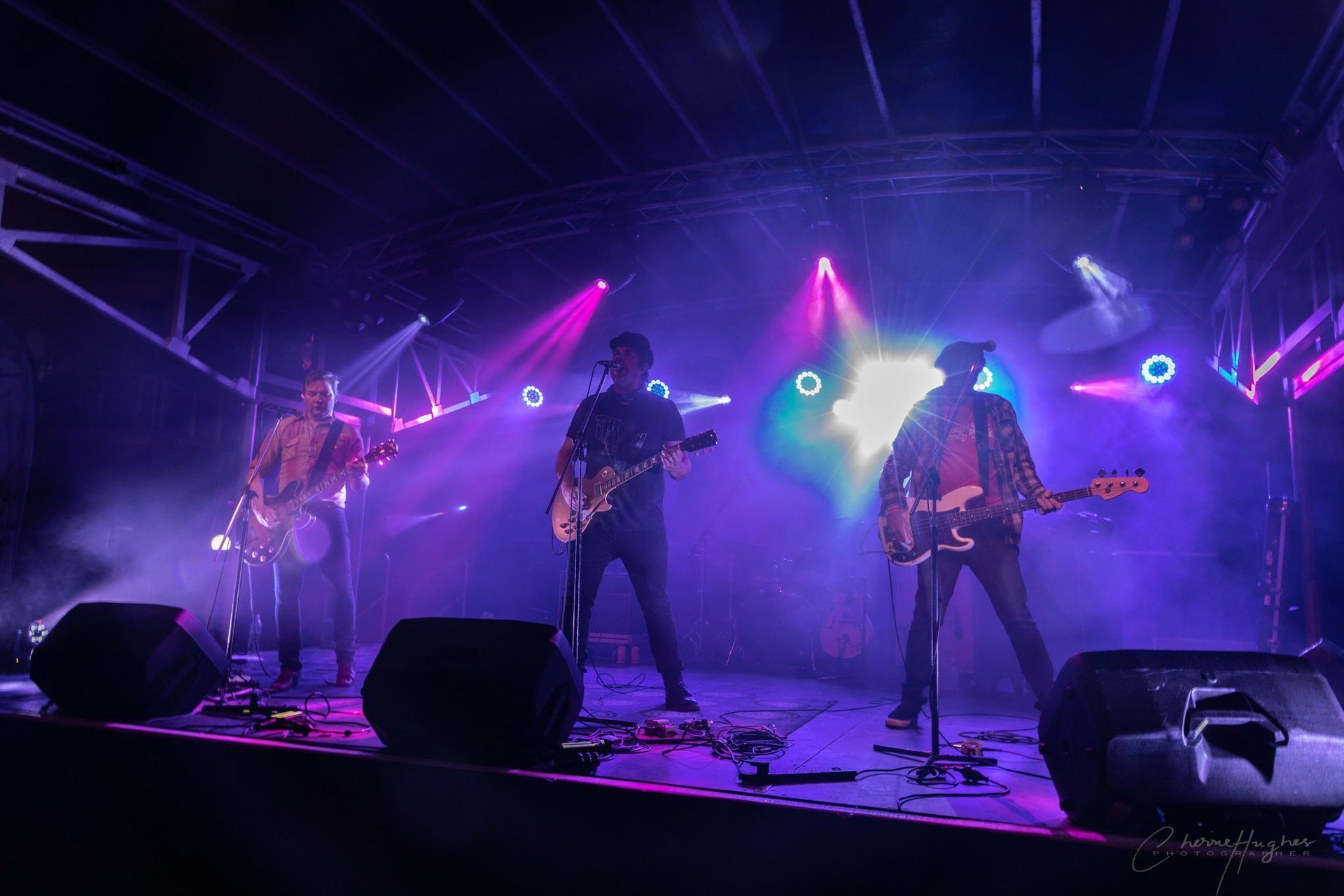 Band On Stage, Playing Instruments Under Colorful Stage Lights — Kennedy Amplifier Hire Service In South Mackay, QLD