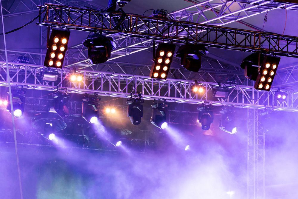 Stage Lights Illuminate A Misty Scene With Purple And Gold Hues — Kennedy Amplifier Hire Service In South Mackay, QLD