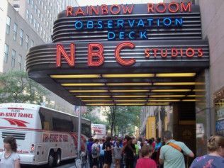 NBC Studios entrance with Rainbow Room Observation Deck sign and pedestrians on a city street