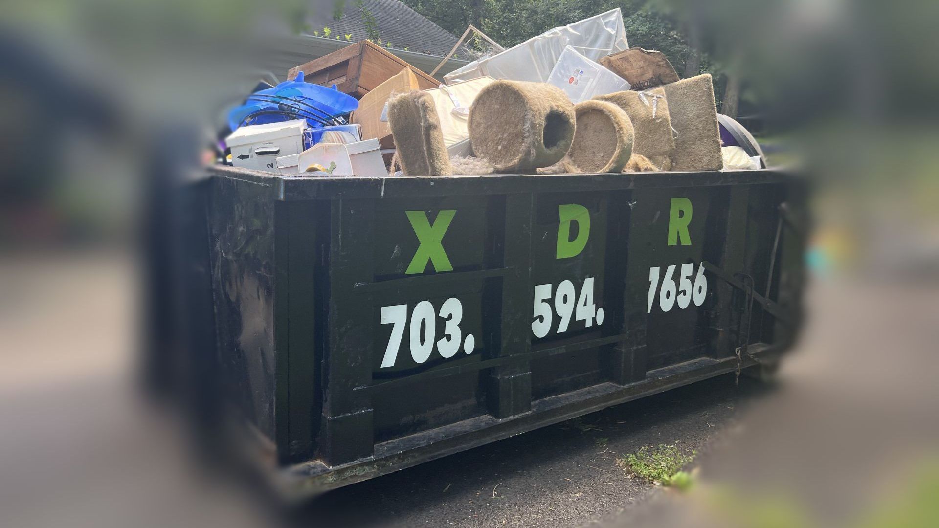 a dumpster filled with house trash