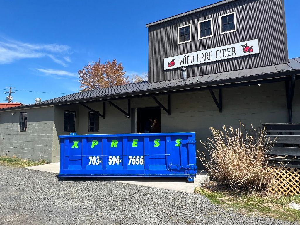 Commercial dumpster placed at a business site in Warrenton, VA, ensuring clean and organized waste disposal.
