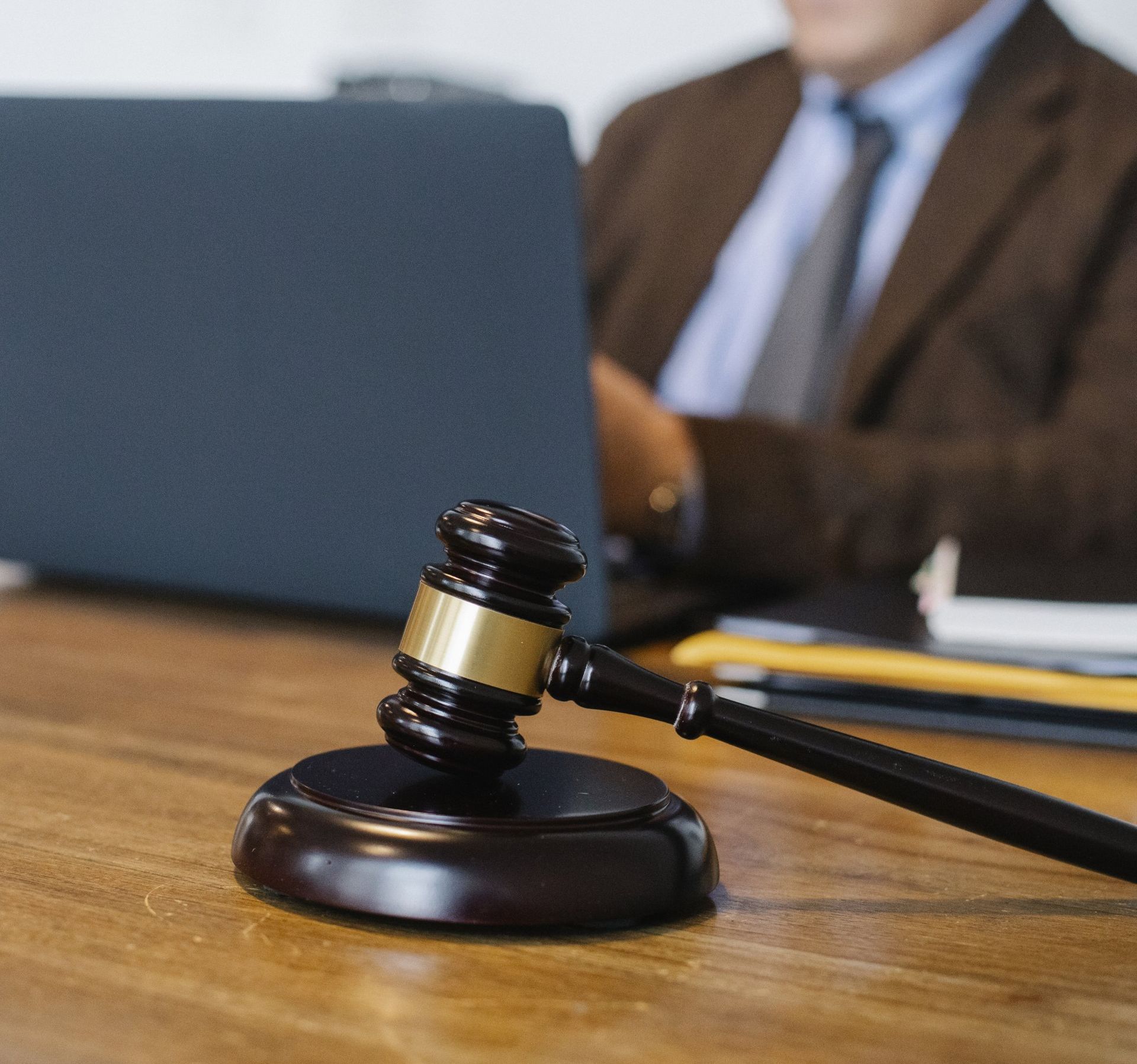 Injury Attorney Typing on Laptop and Legal Gavel