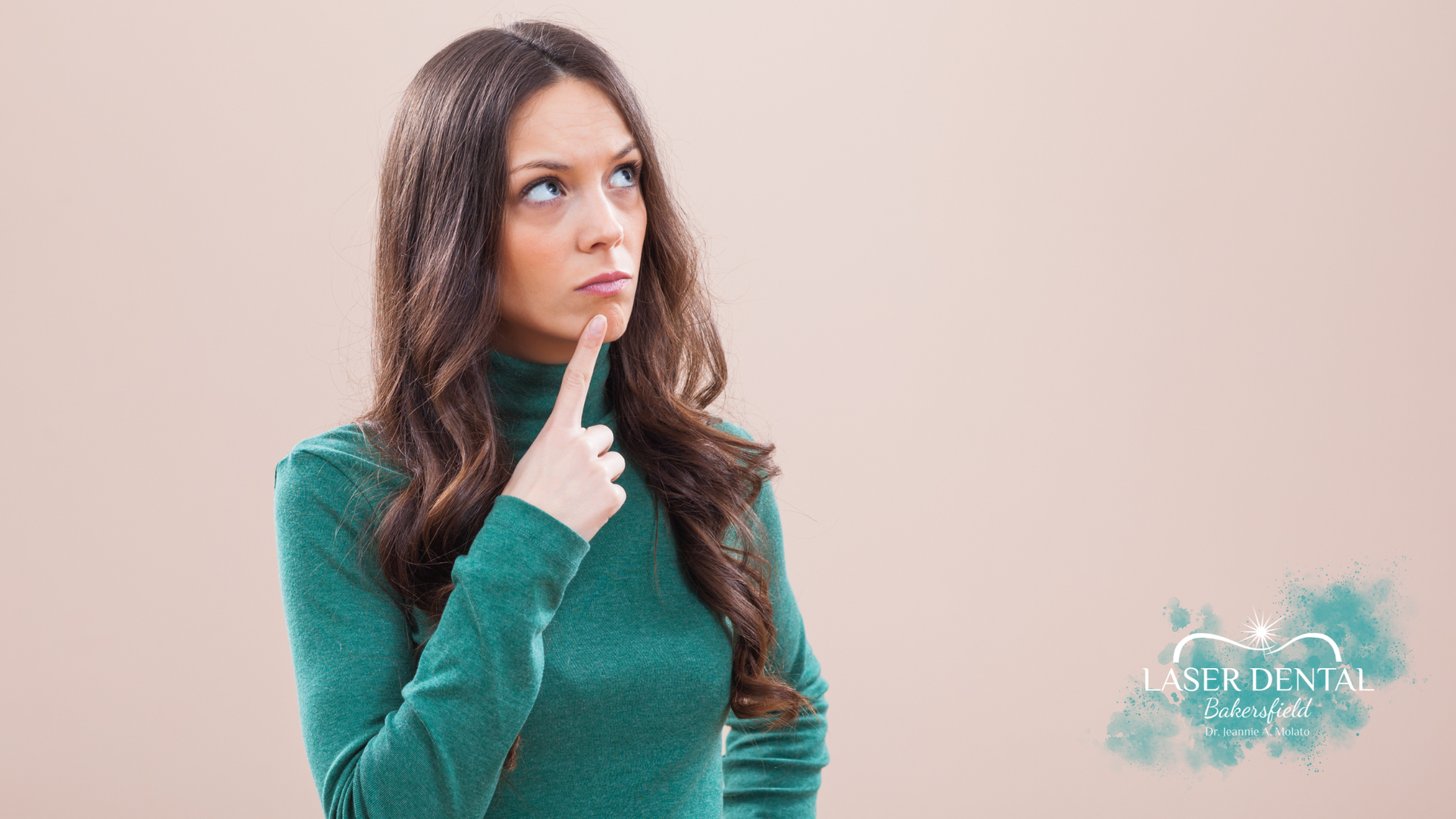 Woman in a green turtleneck looking up, hand on chin, appears thoughtful. Beige background. Laser Dental logo.