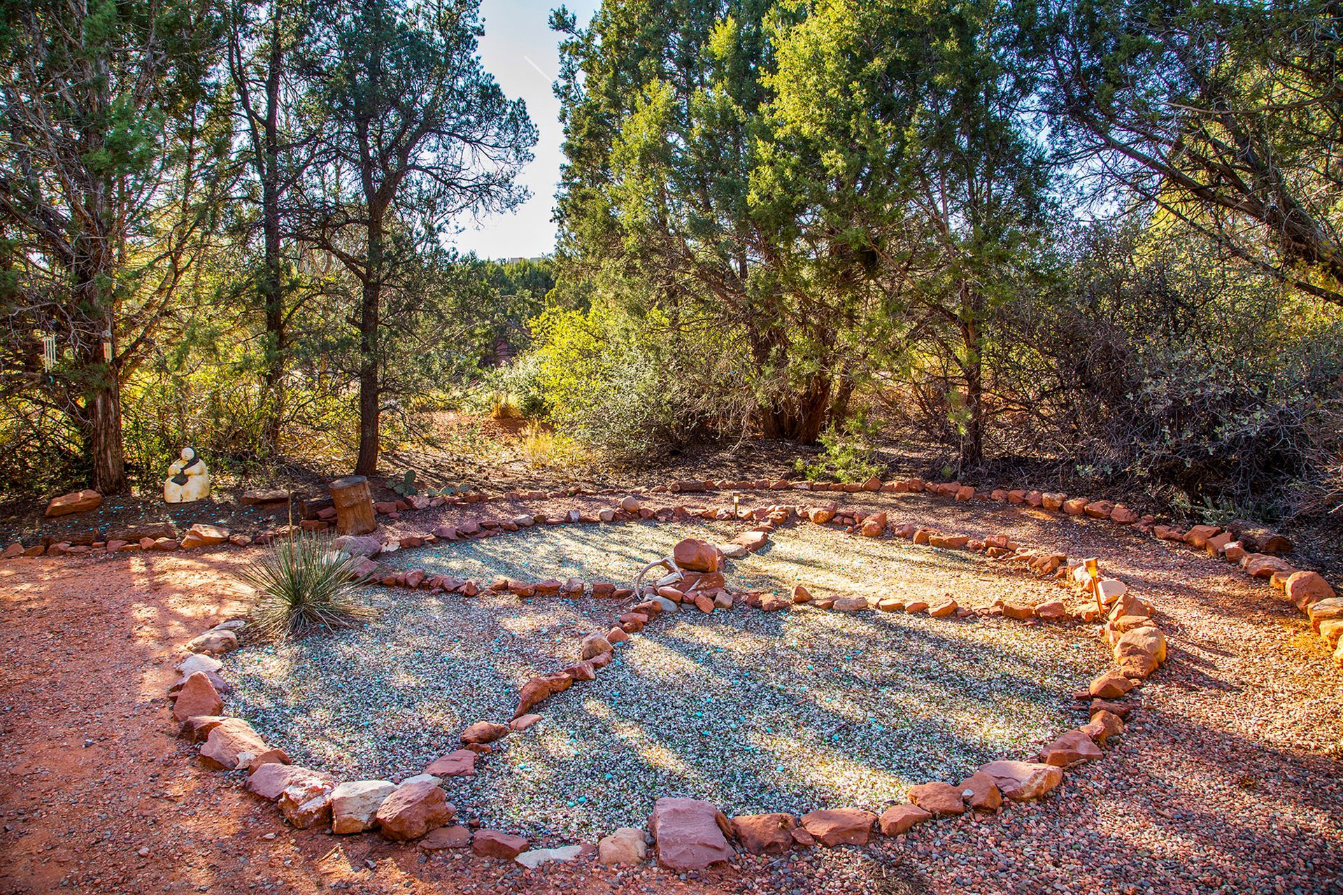 A circle of rocks in the middle of a forest.