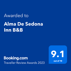 A blue sign that says `` awarded to alma de sedona inn b & b ''