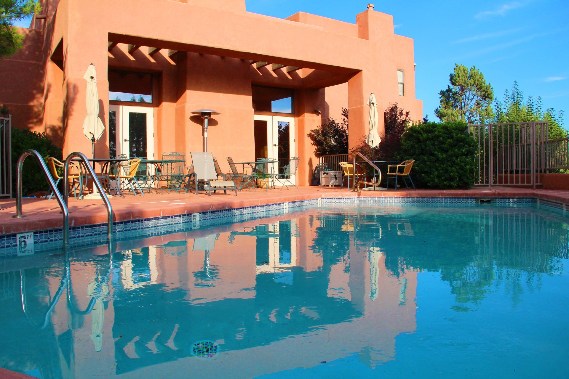A large house with a swimming pool in front of it
