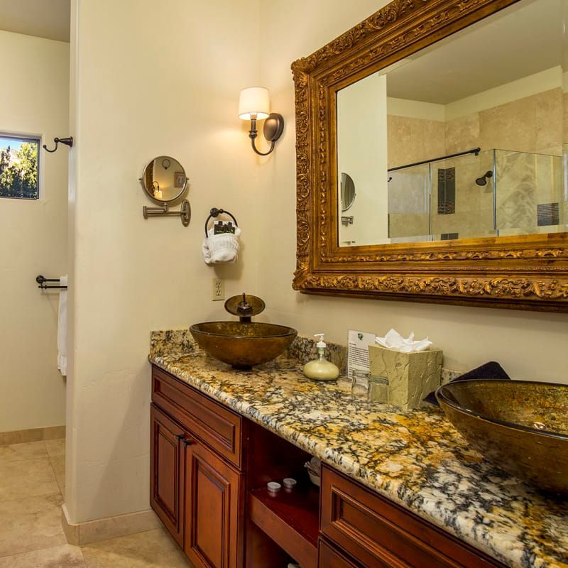 A bathroom with two sinks and a large mirror