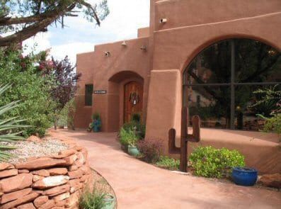 A large house with a cactus in front of it