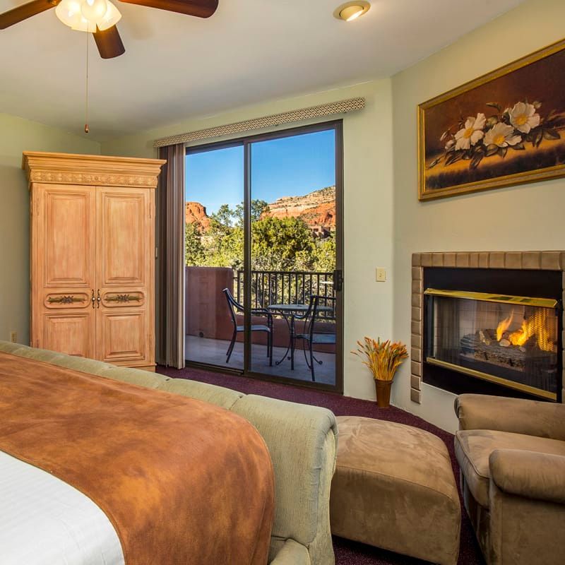 A bedroom with a fireplace and sliding glass doors
