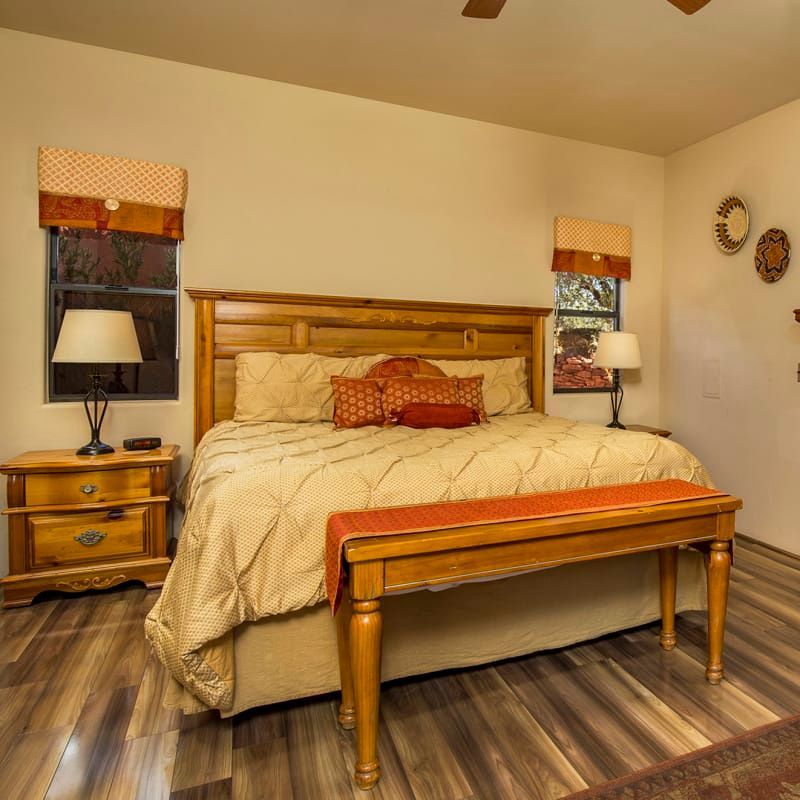 A bedroom with a king size bed and a bench