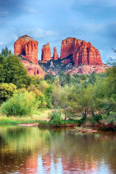 There is a lake in the foreground and a mountain in the background.