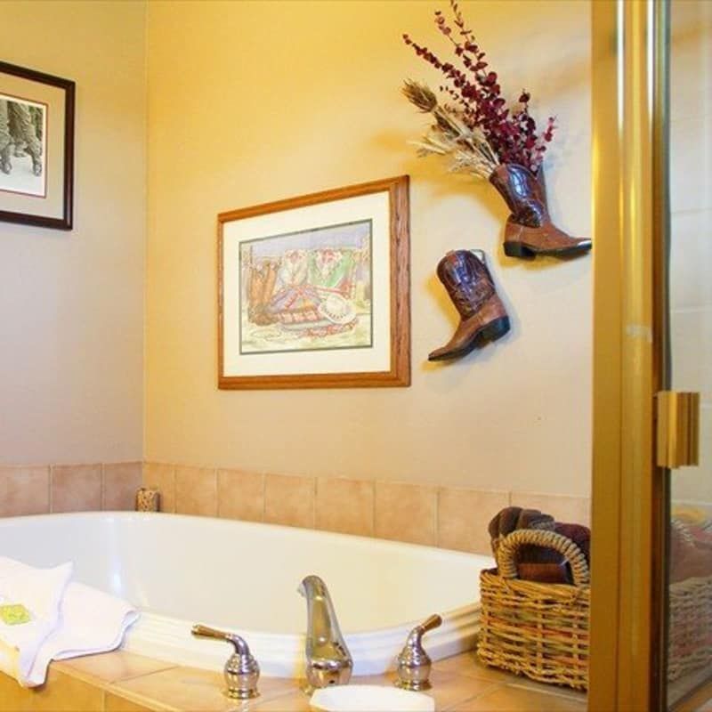 A bathroom with a tub and a picture on the wall