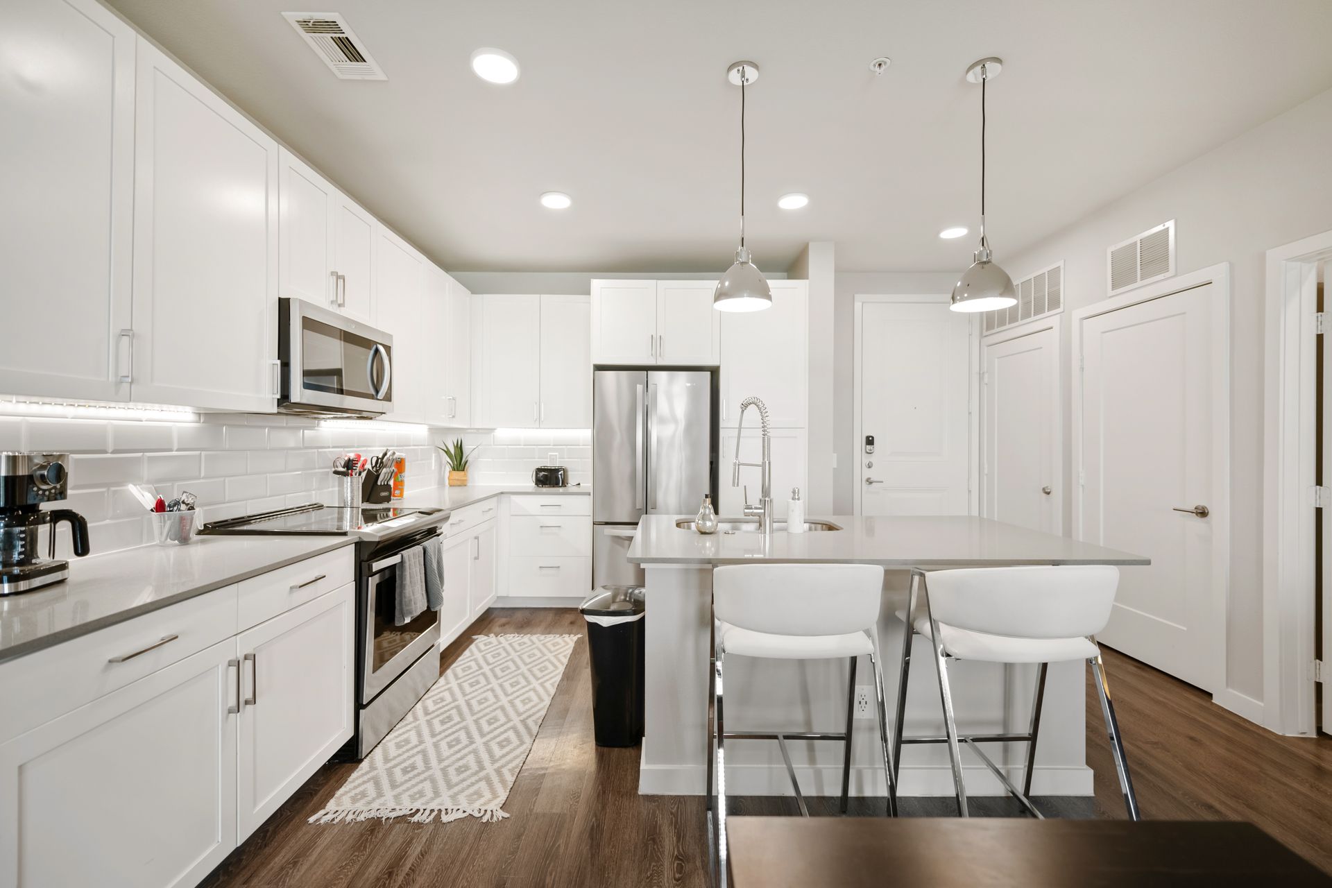 Fully equipped furnished apartment kitchen with cookware, dinnerware and kitchen essentials