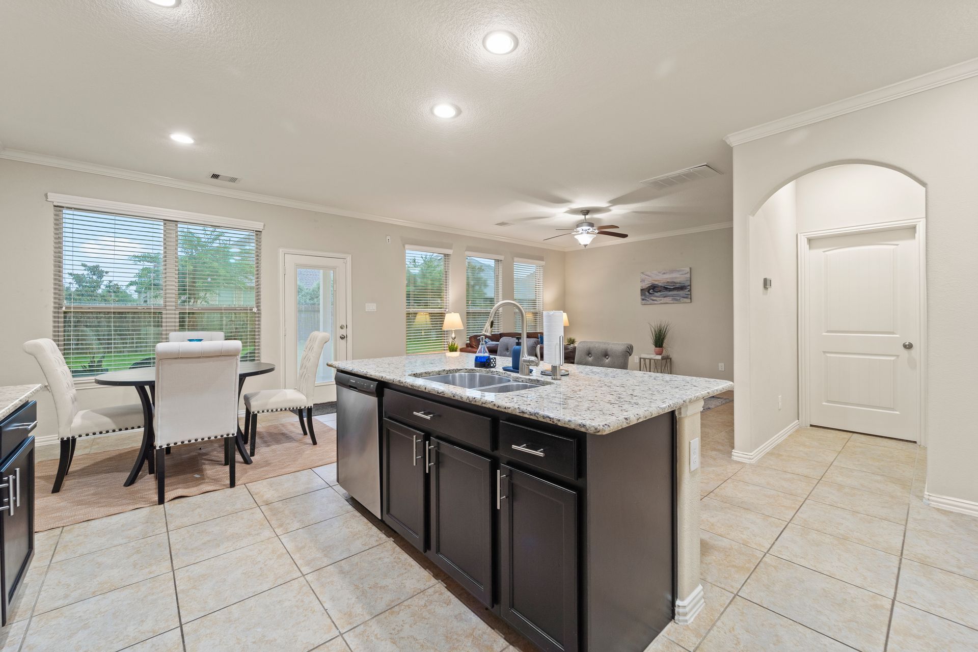 After: A luxurious staged kitchen/ living room of a home in Houston, Texas.
