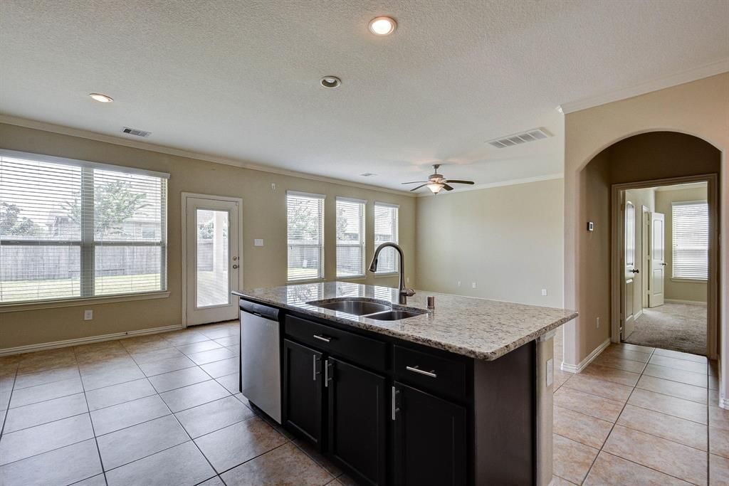 Before: A luxuriously empty kitchen/ living room of a home in Houston, Texas.