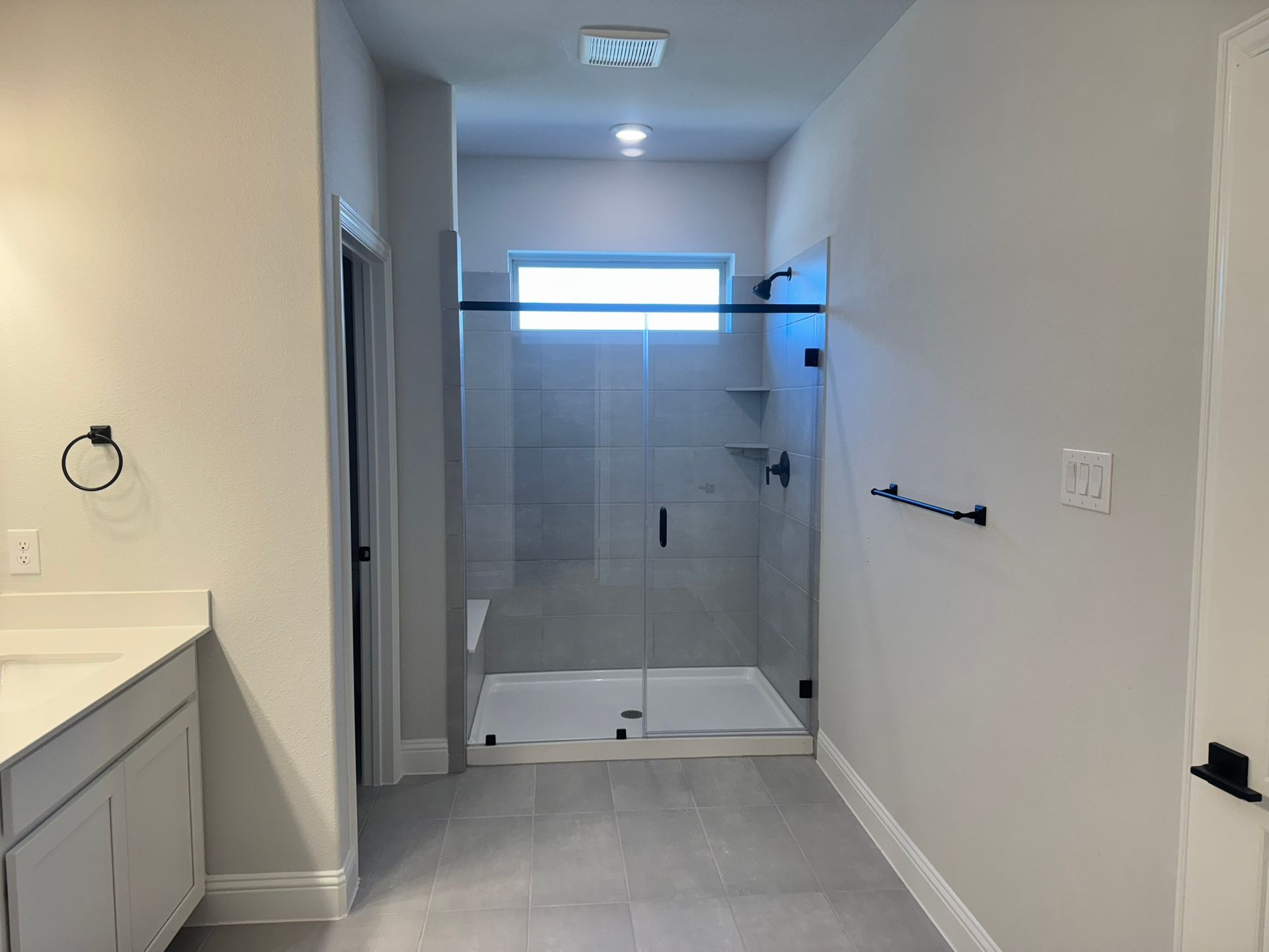Before: currently empty of a spacious and luxurious bathroom in a townhome located in Plano, Texas.