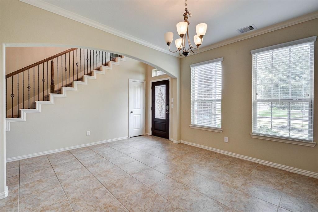 Before: A luxuriously empty living room of a townhome in Houston, Texas.
