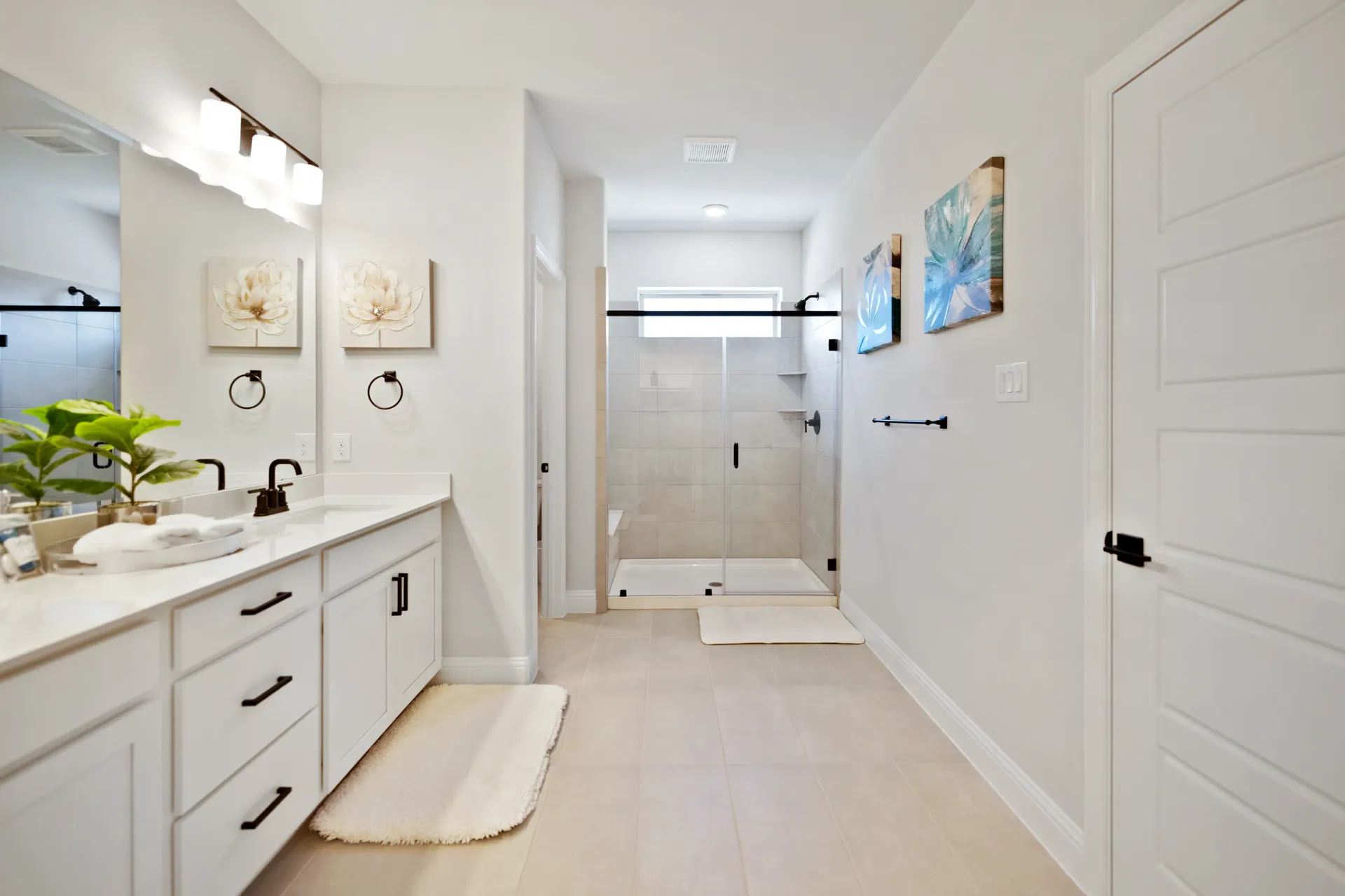 After: This spacious bathroom is luxuriously staged and is located in a townhome in Plano, Texas.