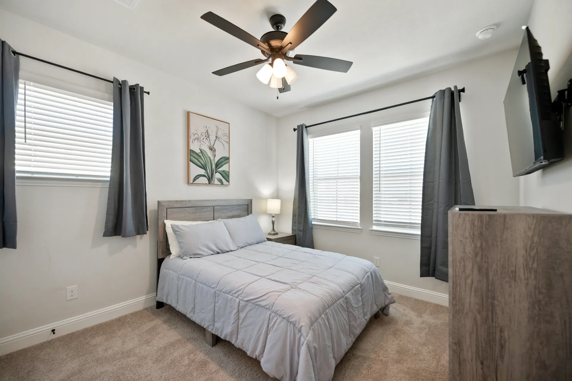 After: Luxuriously staged, spacious bedroom located in a townhome in Plano, Texas.