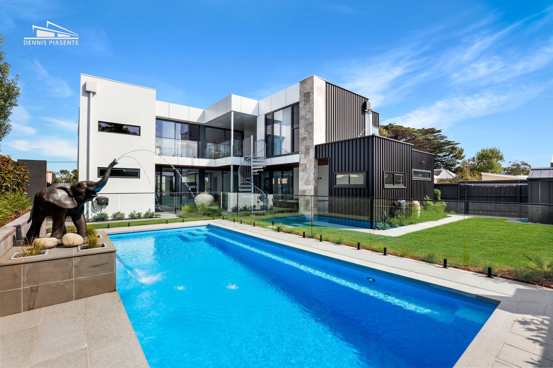 A large house with a swimming pool in front of it.