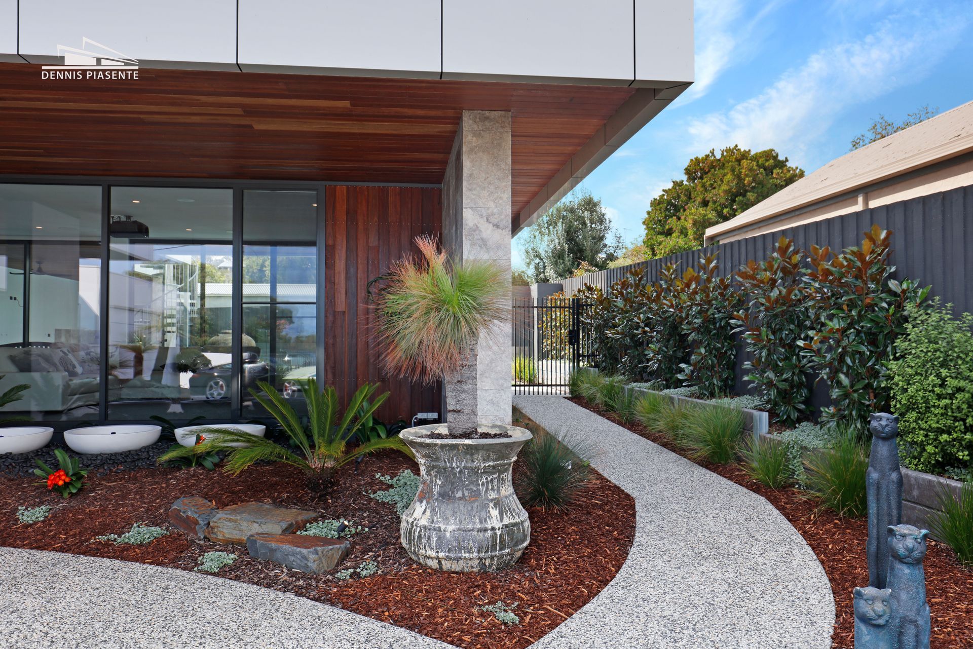 There is a walkway leading to the front of the house.