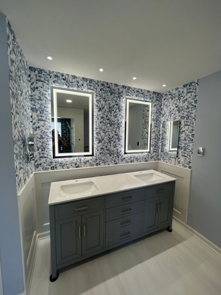 Custom bathroom remodel with layered lighting design and illuminated mirror in Superior Colorado