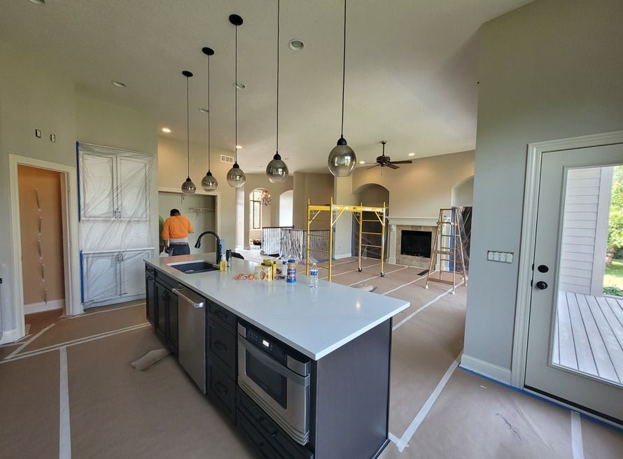 A kitchen in a house under construction with a large island in the middle.