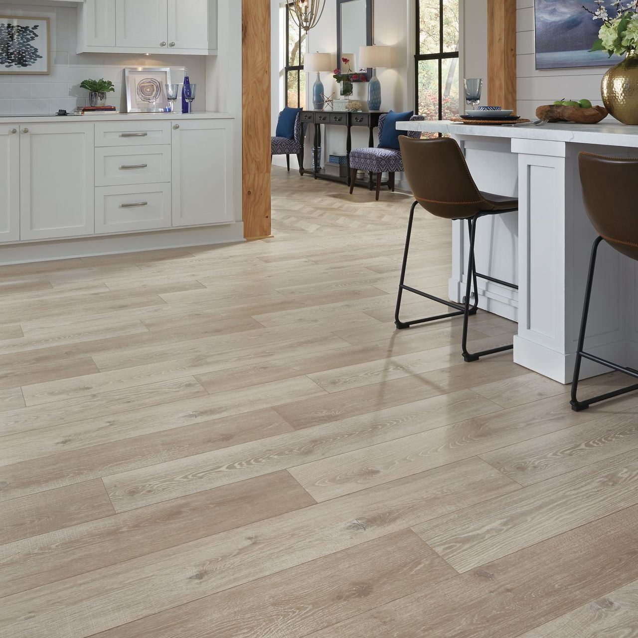 A kitchen with hardwood floors and white cabinets.